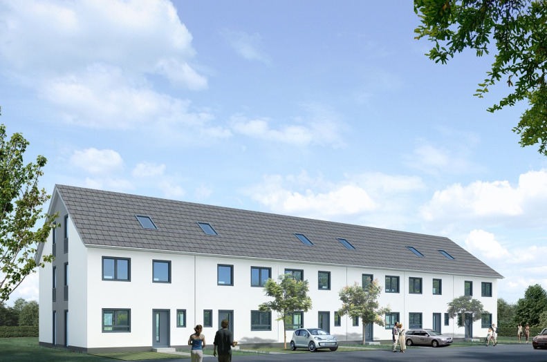 image of three multistory townhouses with small tree's in front of them and a blue sky.
